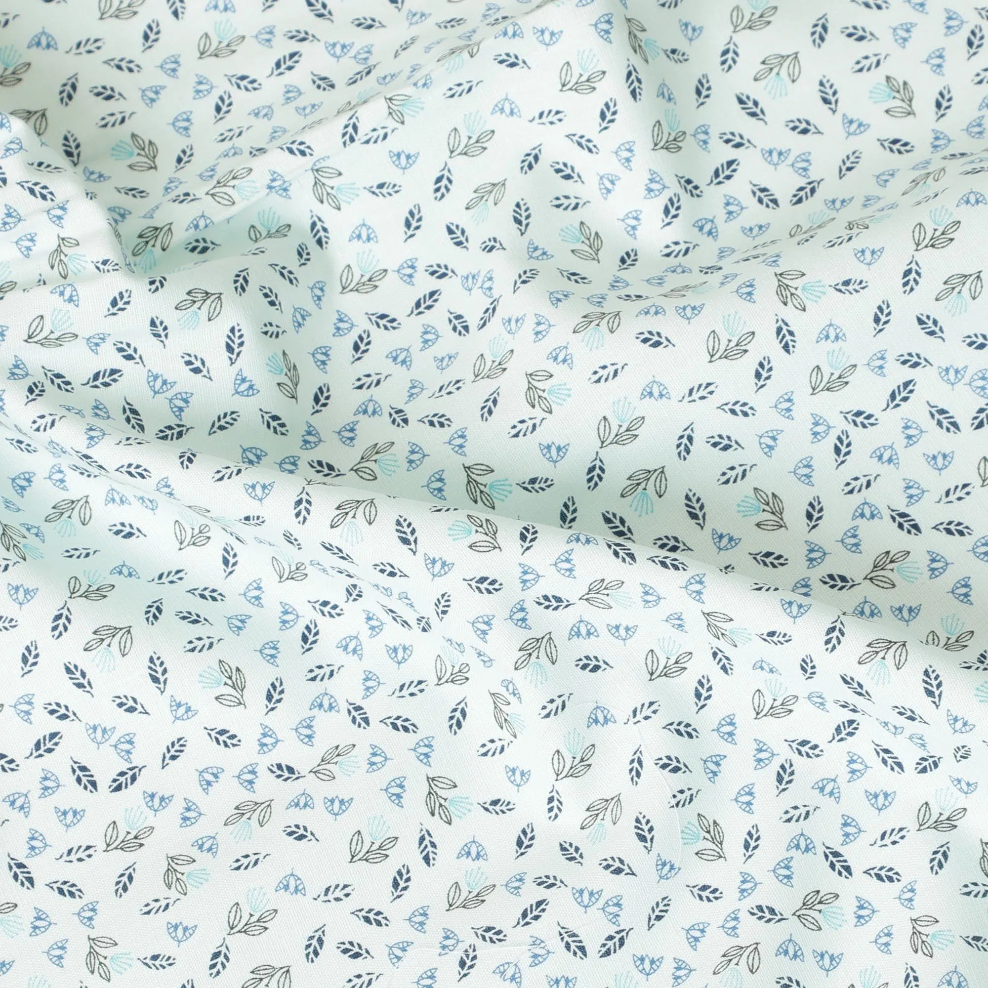Light vista green blended cotton shirting fabric with blue and black print in leaf design-D9633