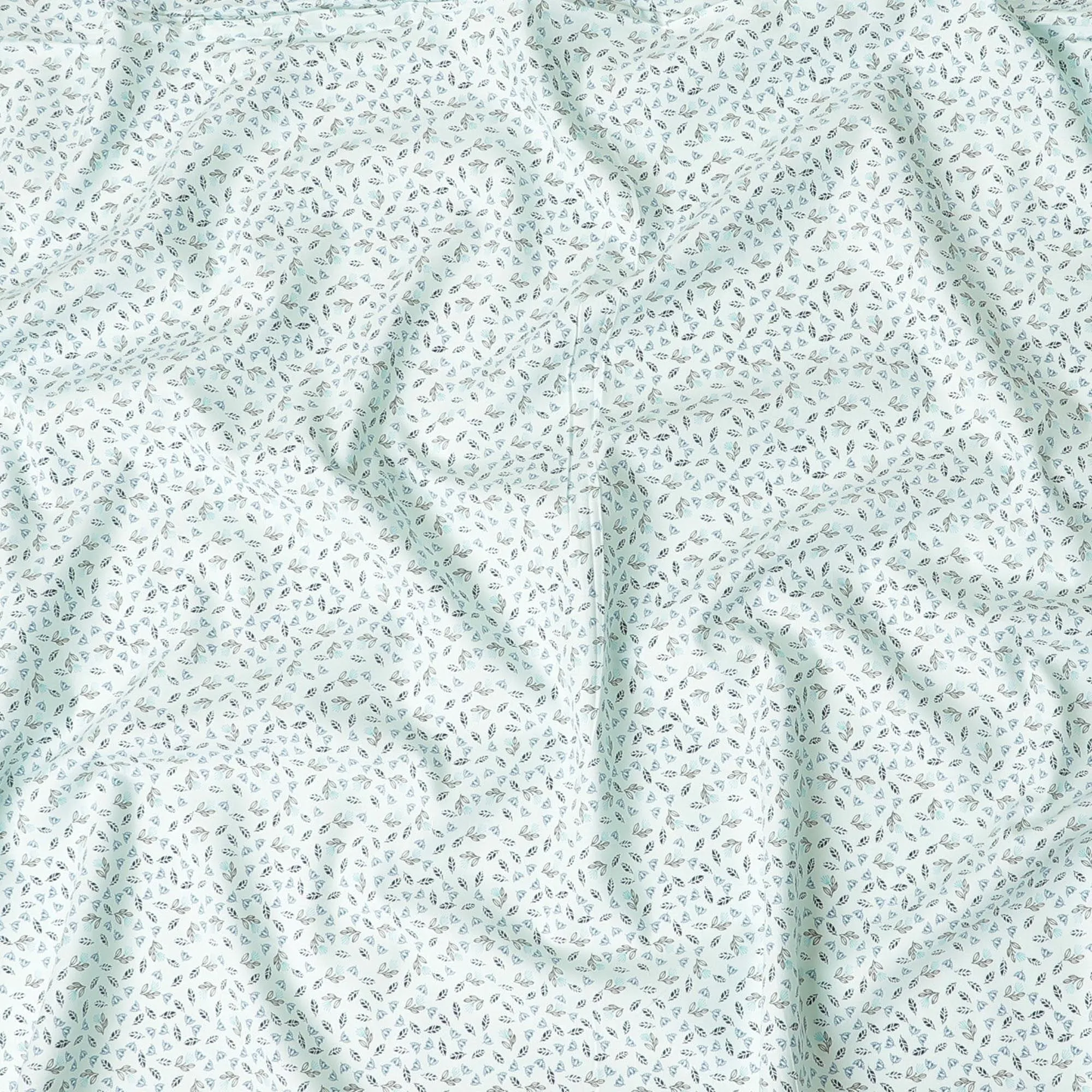 Light vista green blended cotton shirting fabric with blue and black print in leaf design-D9633