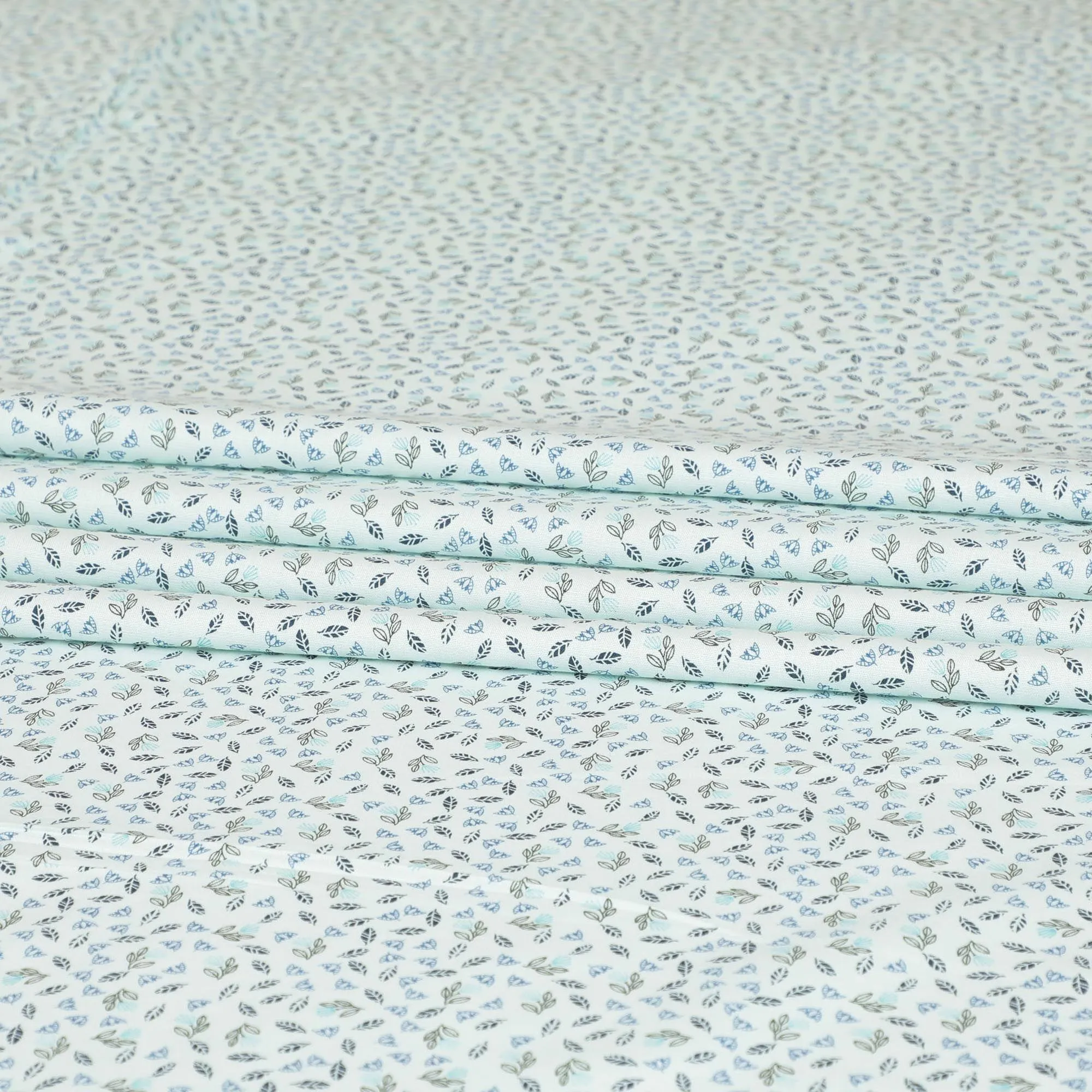 Light vista green blended cotton shirting fabric with blue and black print in leaf design-D9633
